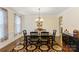 Formal dining room featuring a decorative rug, chandelier, wainscoting, and natural light at 274 Cove Creek Loop, Mooresville, NC 28117