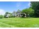 Well-maintained home with a lush green lawn, mature trees, and inviting curb appeal at 274 Cove Creek Loop, Mooresville, NC 28117