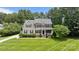 Charming two-story home with manicured lawn, front porch, and lush landscaping at 274 Cove Creek Loop, Mooresville, NC 28117