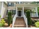 Charming front porch with brick steps, white railings, and manicured landscaping at 274 Cove Creek Loop, Mooresville, NC 28117