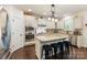 Kitchen features white cabinets, granite countertops, stainless steel appliances and center island at 274 Cove Creek Loop, Mooresville, NC 28117