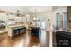 Open kitchen with a large center island, seating, and a view to the backyard patio at 274 Cove Creek Loop, Mooresville, NC 28117
