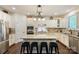 Kitchen features white cabinets, granite countertops, stainless steel appliances, and center island at 274 Cove Creek Loop, Mooresville, NC 28117