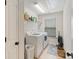 Functional laundry room equipped with a washer, dryer, shelving, and a window for natural light and ventilation at 274 Cove Creek Loop, Mooresville, NC 28117