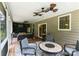 Covered patio with stylish seating, ceiling fans, and outdoor dining area at 274 Cove Creek Loop, Mooresville, NC 28117