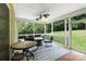 Relaxing screened porch featuring comfortable seating arrangements, ceiling fans, and outdoor views for leisure and entertainment at 274 Cove Creek Loop, Mooresville, NC 28117