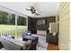 Inviting screened porch with comfortable seating, a flat-screen TV, and serene views of the outdoors for relaxation at 274 Cove Creek Loop, Mooresville, NC 28117