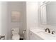 A cozy bathroom with white cabinets, a modern toilet, and an elegant mirror at 3112 Planters Ridge Rd, Charlotte, NC 28270