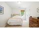 Comfortable bedroom with a twin bed, wood dresser and a window with blind shades at 3112 Planters Ridge Rd, Charlotte, NC 28270