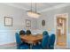 Formal dining room with a wooden table, leather chairs, and an elegant chandelier lighting at 3112 Planters Ridge Rd, Charlotte, NC 28270