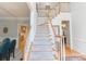 Grand foyer featuring a carpeted staircase and hardwood floors, providing a warm welcome to the home at 3112 Planters Ridge Rd, Charlotte, NC 28270