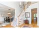 Bright foyer with hardwood floors, elegant staircase, and a view into the formal dining room at 3112 Planters Ridge Rd, Charlotte, NC 28270