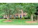Charming brick home with a well-manicured lawn and mature trees, offering great curb appeal at 3112 Planters Ridge Rd, Charlotte, NC 28270