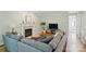 Spacious living room with a fireplace, hardwood floors, and a large sectional sofa at 3112 Planters Ridge Rd, Charlotte, NC 28270