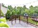 Spacious, wood back deck overlooking lush green backyard with playset, trampoline and mature trees and landscaping at 3609 Benseval Ln, Matthews, NC 28105