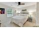 Bright bedroom with neutral colors, ceiling fan, and large window offering natural light at 3609 Benseval Ln, Matthews, NC 28105