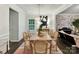 Elegant dining room with neutral tones, modern lighting, and adjacent living area at 3609 Benseval Ln, Matthews, NC 28105