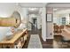 Bright foyer with dark hardwood floors, neutral walls, and decorative accents leading to living spaces at 3609 Benseval Ln, Matthews, NC 28105