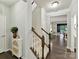 Hallway with staircase, neutral decor, hardwood floors, and entry to a bright sunroom and dining space at 3609 Benseval Ln, Matthews, NC 28105
