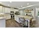Spacious kitchen with white cabinets, a kitchen island, and stainless steel appliances at 3609 Benseval Ln, Matthews, NC 28105