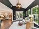 Sunroom with dark accent wall, leading to living room and featuring white trim and ample natural light at 3609 Benseval Ln, Matthews, NC 28105