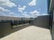 A balcony with a view of the surrounding neighborhood on a sunny day at 3618 S Tryon St # 19, Charlotte, NC 28217