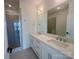 Bathroom featuring double vanity with quartz countertops and a glass-enclosed shower at 3618 S Tryon St # 19, Charlotte, NC 28217