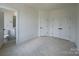 A bright bedroom with neutral carpet sits adjacent to the bathroom at 3618 S Tryon St # 19, Charlotte, NC 28217