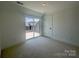 Bedroom with a sliding glass door leading to an outdoor balcony terrace at 3618 S Tryon St # 19, Charlotte, NC 28217