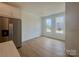 Dining area with stainless steel refrigerator and bright windows, offering a modern living space at 3618 S Tryon St # 19, Charlotte, NC 28217