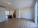 Open-concept living space featuring wood floors, kitchen, and staircase offering a seamless design at 3618 S Tryon St # 19, Charlotte, NC 28217