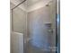 Modern walk-in shower featuring gray tile, a built-in seat, and sleek fixtures at 3618 S Tryon St # 19, Charlotte, NC 28217