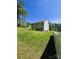 Large backyard with lush green grass and mature trees, offering a serene and private outdoor space at 3816 Rosewood Dr, Mount Holly, NC 28120