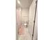 Clean bathroom featuring a white toilet, patterned floor tiles, and a pink shower curtain at 3816 Rosewood Dr, Mount Holly, NC 28120