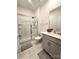 Bathroom featuring a glass enclosed shower, modern vanity, and elegant marble hexagon tile flooring at 3816 Rosewood Dr, Mount Holly, NC 28120