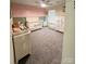Bright Bedroom with a crib, soft carpet, and a pink accent wall at 3816 Rosewood Dr, Mount Holly, NC 28120