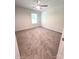 Minimalist bedroom features soft carpet, a window, and neutral paint at 3816 Rosewood Dr, Mount Holly, NC 28120