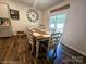 Bright dining room with a large wooden table, accent wall decor, and sliding glass doors at 3816 Rosewood Dr, Mount Holly, NC 28120