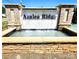 Elegant community entrance featuring a stone sign and a tranquil water feature, welcoming residents and guests at 3816 Rosewood Dr, Mount Holly, NC 28120