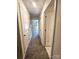 Hallway featuring neutral paint, carpet flooring, and multiple doorways at 3816 Rosewood Dr, Mount Holly, NC 28120