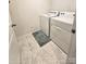 Functional laundry room features a washer, dryer, and patterned tile flooring at 3816 Rosewood Dr, Mount Holly, NC 28120
