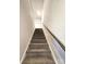 Carpeted staircase with handrail leading to the upper level of the house at 3816 Rosewood Dr, Mount Holly, NC 28120