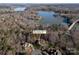 Aerial view of 394 Stone Cliff Lane. Luxury home on the lake with mature trees at 394 Stonecliff Ln, Clover, SC 29710