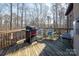 Outdoor deck with grill and seating, surrounded by a tranquil woodland setting at 394 Stonecliff Ln, Clover, SC 29710