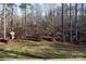 Backyard featuring a charming playhouse and swing set, perfect for outdoor activities at 394 Stonecliff Ln, Clover, SC 29710