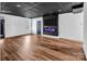 Finished basement offers modern lighting, sleek black ceiling, and an electric fireplace, creating a cozy and stylish space at 394 Stonecliff Ln, Clover, SC 29710