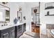 Well-lit bathroom with double vanities, stylish blue and white porcelain vase and a glimpse of the bedroom at 394 Stonecliff Ln, Clover, SC 29710