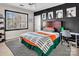 This bedroom boasts a dark accent wall, modern lighting, and a large window offering ample natural light at 394 Stonecliff Ln, Clover, SC 29710