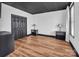 Bedroom with modern lamps, black paneled doors, a textured black ceiling, and wood look floors creates a cozy and inviting atmosphere at 394 Stonecliff Ln, Clover, SC 29710