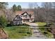 Spacious home with stone and siding, featuring a well-maintained lawn and a circular driveway at 394 Stonecliff Ln, Clover, SC 29710